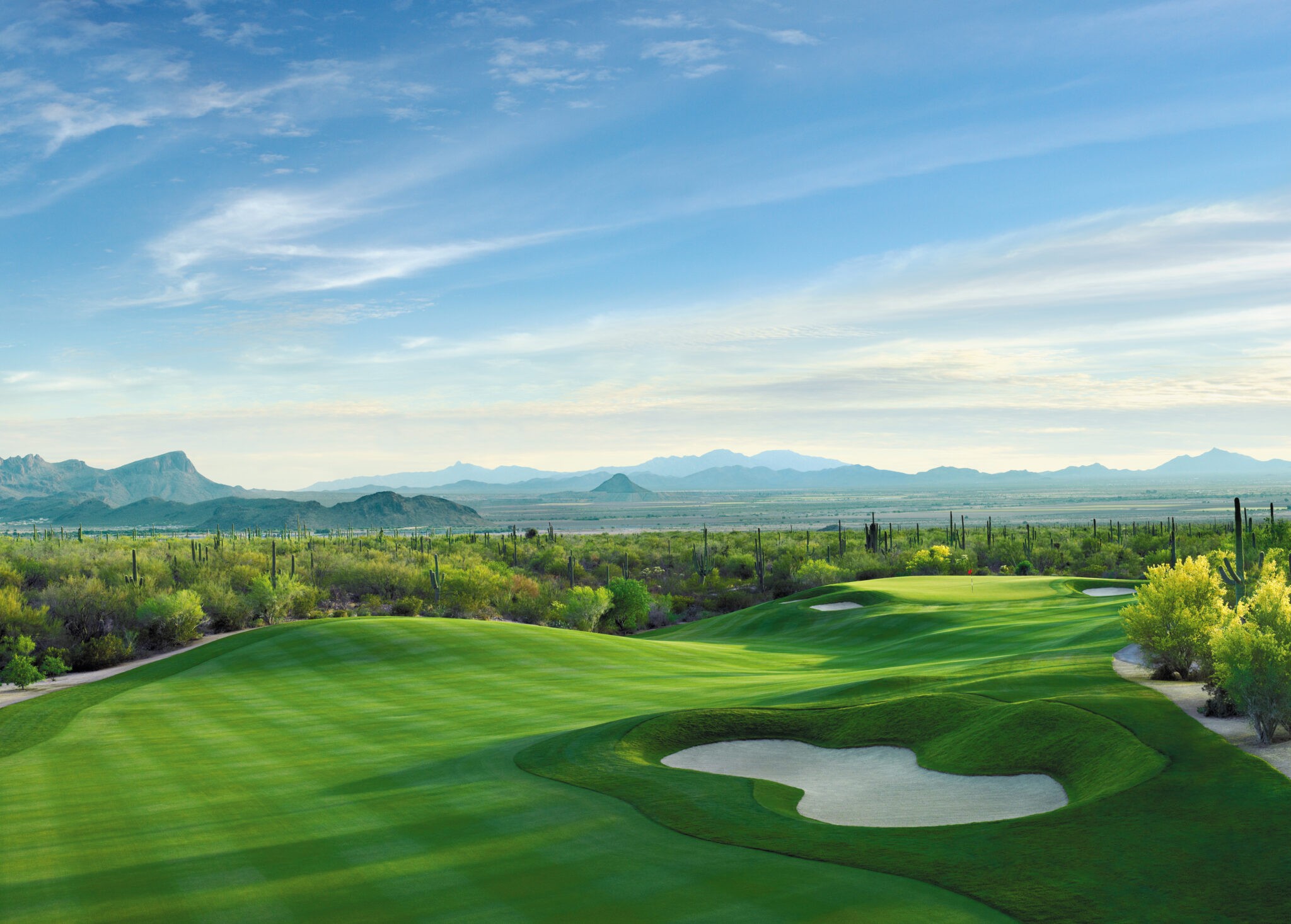 Sunny afternoon view of a golf course hole named Dove Mountain in Tucson, AZ.