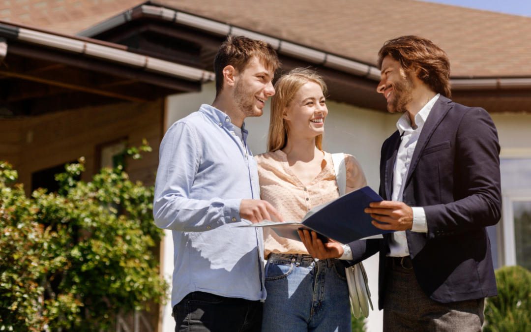 Realtor showing a couple a home - standing outside the home.