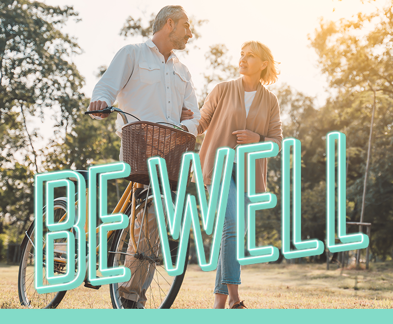 Department Image: BE WELL. Mature couple walking on trails.