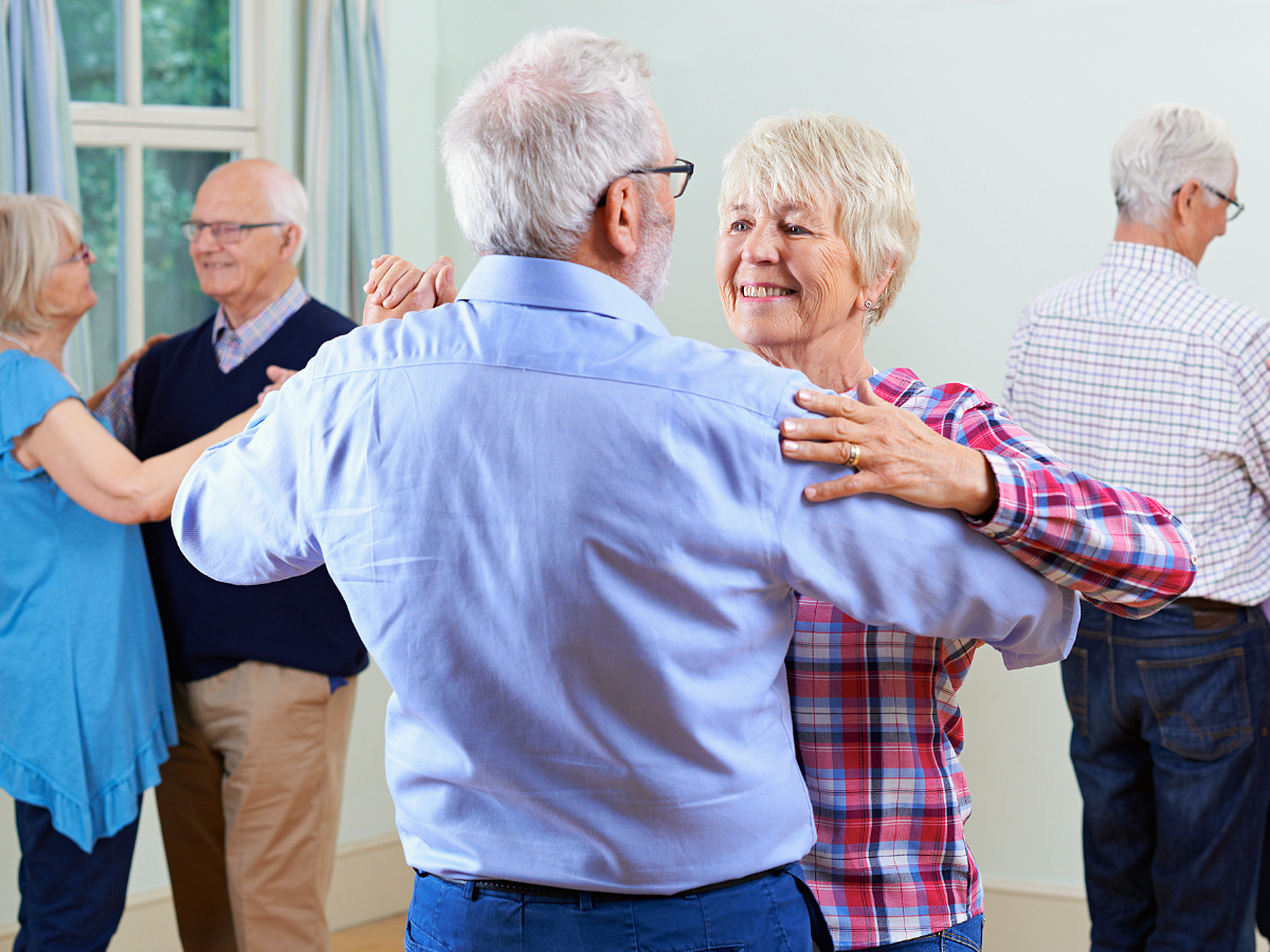 Senior adults learning to dance in a class.